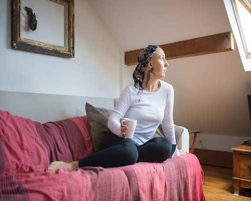 A serene living room setup where a person rests on a sofa, highlighting an atmosphere of calm and physical recovery