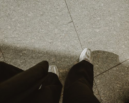 Close up of ergonomic modern casual shoes on urban floor, representing daily comfort choices